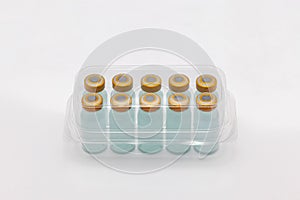Ten vaccine bottles inside closed translucent plastic box