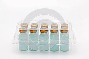 Ten vaccine bottles inside closed translucent plastic box