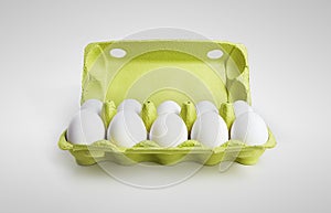 Ten white eggs in a carton box