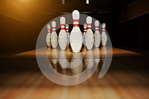 Ten white pins in a bowling alley lane