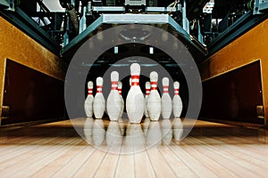 Ten white pins in a bowling alley lane
