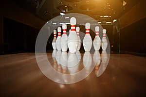 Ten white pins in a bowling alley lane