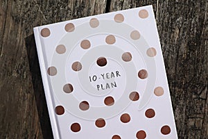 Ten Year Plan Book on Wooden Background