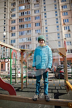 A ten years boy is standing on playground in Moscow