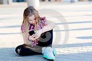 Ten years girl using smartphone