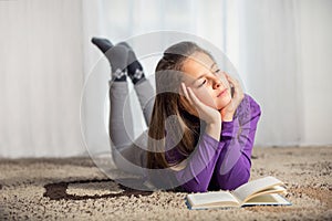 Ten years old girl with a books photo