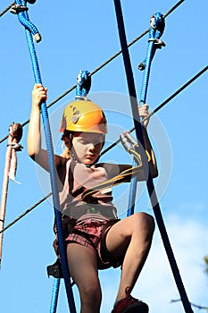 tenager climbing a rope park, Girl climbing in adv