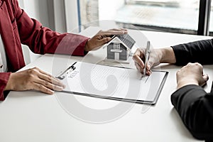 The tenant is signing a lease agreement with the landlord after viewing the home and discussing the rental agreement details.