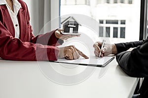 The tenant is signing a lease agreement with the landlord after viewing the home and discussing the rental agreement details.