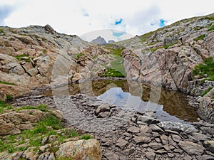 Tende - Panoramic view of small glacier pond in the Mercantour National Park in the Valley of Marvels near Tende