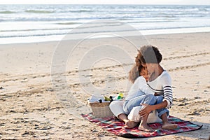 Tender African American family on picnic on beach