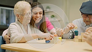 Tender caregiver helping a senior woman in a geriatrics