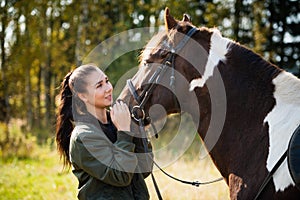 Tender communication between a rider and her horse before a riding lesson