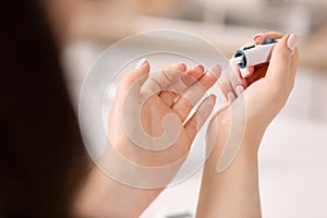 Tender female hands carrying out blood sugar test