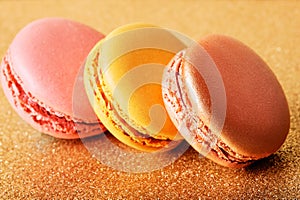 french cookies macaron on golden backgrouns photo