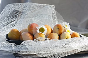 Tender fresh apricots on a black dish
