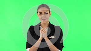Tender girl with folded arms in front of her and tears in her eyes. Green screen