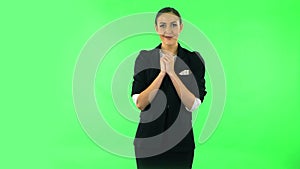 Tender girl with folded arms in front of her and tears in her eyes. Green screen