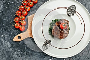 Tender lean medium rare beef fillet steak medallions with one sliced through to show the red meat with spinach, Restaurant menu,