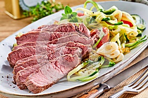 Tender medium rare roast beef with salad