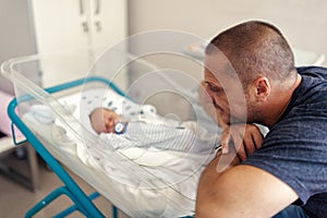Tender moment between a father and his newborn baby