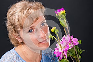 Tender pensive woman 45 years old with flowers