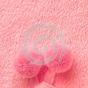 Tender pink texture of towel like background with pompons, close photo