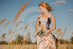 Tender portrait of a blonde girl in a lingerie on the field