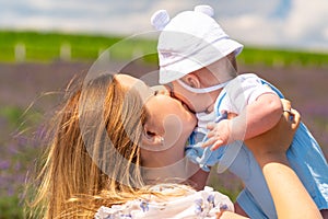 Tender portrait of a young mother kissing her baby