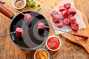 Tender prime beef being cooked in a fondue