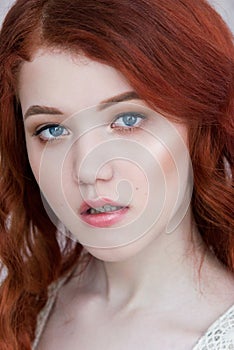 Tender retro portrait of a young beautiful dreamy redhead woman.