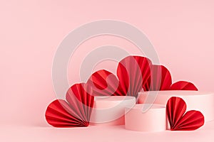 Tender soft light pastel pink stage mockup with three round podiums, passion red paper hearts of asian fans in chinese style.