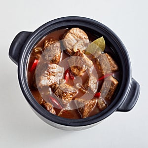 Tender spicy beef goulash in a top down view photo