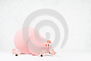 Tender spring floral background in japanese style - pink sakura flowers, pink circles, paper fans on white table as stage.