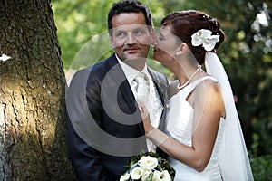 Tender wedding kiss photo