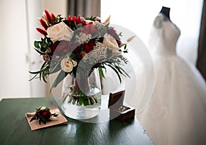 Tender weddingday. Wedding bouquet and blurred wedding dress photo