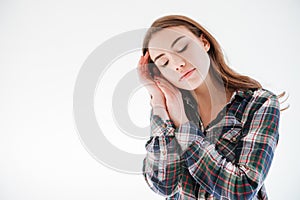 Tender woman with eyes closed standing and touching her face