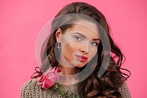 Tender woman portrait over pink background