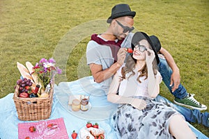 Tender young couple having picnic outdoors