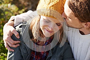 Tender young love. an affectionate young couple spending time together outdoors.