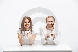 Tenderless redhead girl and boy drinking coffee sitting at w
