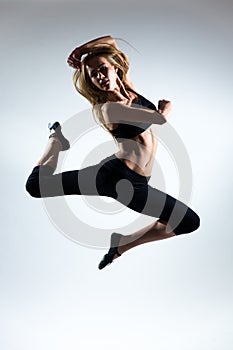 Tenderness, grace, melody and plastic of gymnastic girl. Grace jump in the air of nice young girl