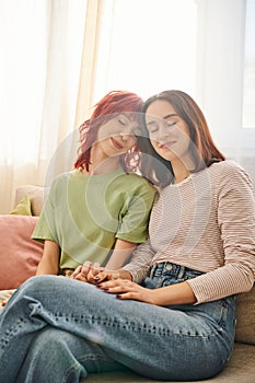 tenderness, young and pleased lesbian couple