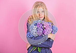 Tenderness of young skin. Springtime bloom. Simple beauty. Girl cute blonde hug hydrangea flowers bouquet. Natural