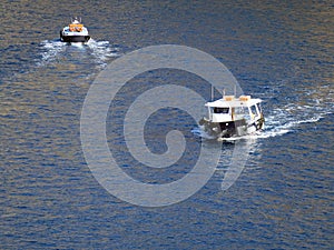 Tenders ferry passengers from cruise ship to  Santorini