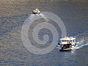 Tenders ferry passengers from cruise ship to  Santorini