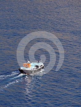 Tenders ferry passengers from cruise ship to  Santorini