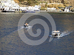 Tenders ferry passengers from cruise ship to  Santorini