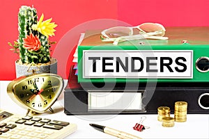 Tenders. The inscription on the folder, against the background of a calculator, a planning clock and cash coins.