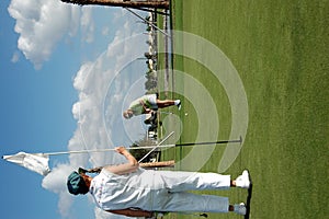 Tending flag on golf green